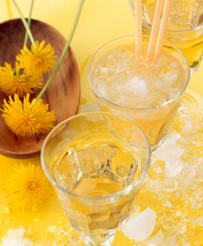 A glass of gomemade dandelion flower liqueur