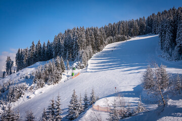 Winter landscape in the Alps. Frosty sunny day. Ski slope in ski resort Mayrhofen, Austria. Zillertal valley