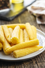 Pickled young baby corn cobs on plate