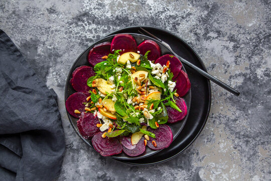 Salad leaves with beetroot, apple, feta and roasted pine nuts