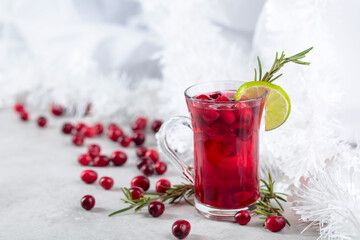 Christmas cranberry drink with berries, lime, and rosemary.