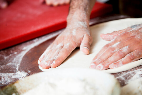 Flatten and shape pizza dough