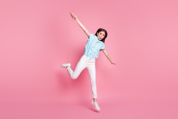 Fototapeta na wymiar Full body photo of astonished girl jump hold hands wear white gumshoes isolated over pink color background