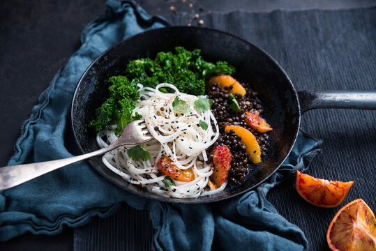 Vegan tapioca pasta with beluga lentils, kale, blood oranges and coriander