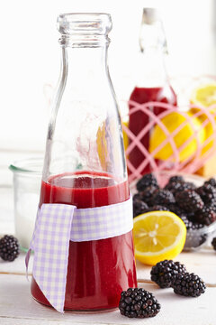 A bottle of fruity blackberry liqueur with a bow