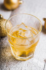 Whiskey on the rocks with winter christmas decorations. Selective focus. Shallow depth of field.