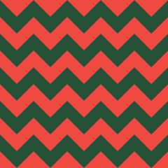 Zig zag Christmas and new year pattern. Regular chevron stripes of red and green color. Classic zigzag lines abstract geometry background. Seamless texture print. Vector illustration