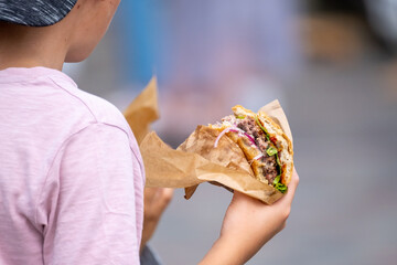 Anonymous child with delicious burger