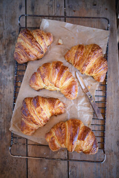 Freshly baked croissants on rustic background