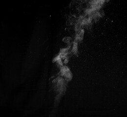 White smoke on black background. Figured smoke on a dark background. Abstract background, design element