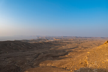 Fototapeta na wymiar Tourists gather at Edge of the World escarpment near Riyadh, Saudi Arabia