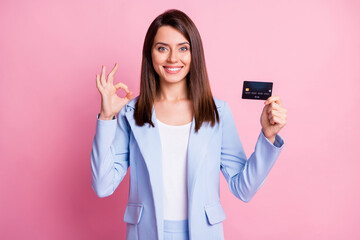 Photo of young beautiful positive good mood bossgirl show okay sign hold credit card isolated on pink color background