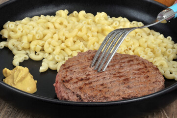 Plate of pasta with a minced steak close-up
