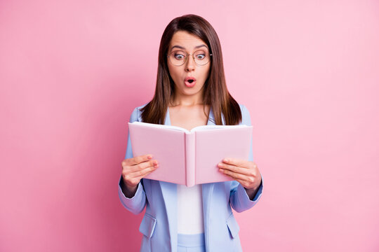 Photo of young beautiful woman amazed shocked news information novelty read book isolated over pastel color background