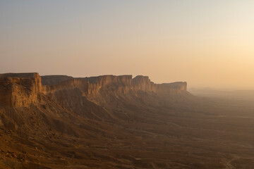Fototapeta na wymiar Tourists gather at Edge of the World escarpment near Riyadh, Saudi Arabia