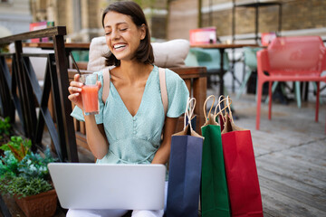 Young woman holding laptop outdoor in summer. Technology, people, happiness concept