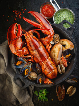 Cooked lobster, mussels and prawns with bread in a pot