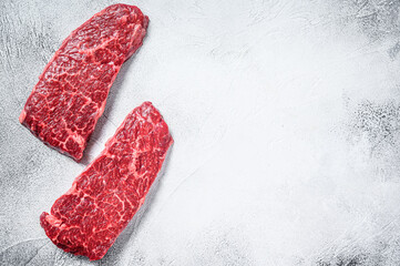 Marble beef Denver steak. Organic meat. Gray background. Top view. Copy space.