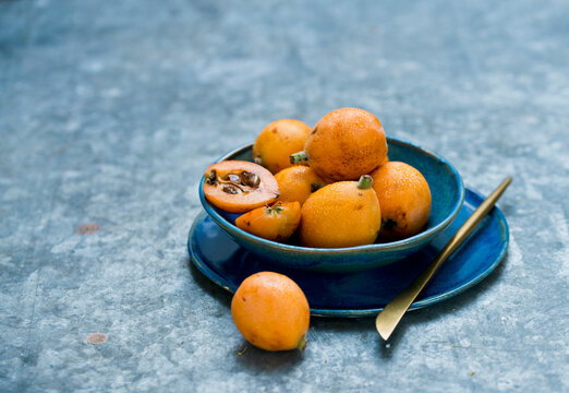 Medlar fruits in blue bowl