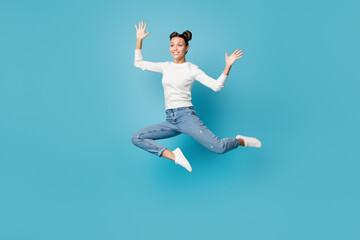 Obraz premium Full length photo of girl jump palms look far away wear white sweater jeans footwear isolated blue color background