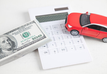 Car, calculator and money on white background.