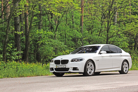 Kiev, Ukraine - May 17, 2014: BMW 520 TDI (F10) M Sport in the forest. 