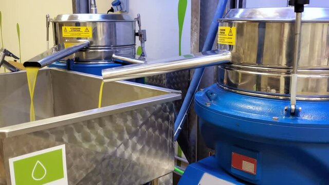 Olive oil industrial milling machine working on cold press extraction in modern Italian extra virgin oil farm