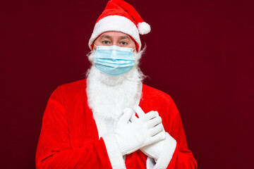 Fototapeta na wymiar Santa Claus wears face mask shows love gesture. coronavirus covid-19 during quarantine.Closeup.
