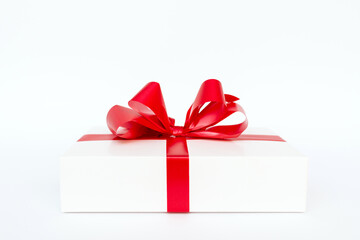 Cristmas white gift box present red bow white background.