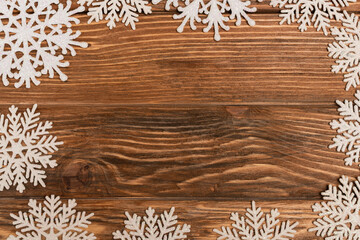 top view of winter snowflakes on wooden 