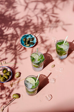 Mojito coctails in a sunshine with capers and olives