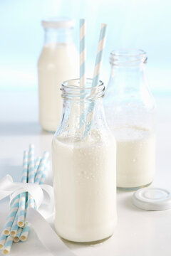 Cold, fresh milk in bottles with straws