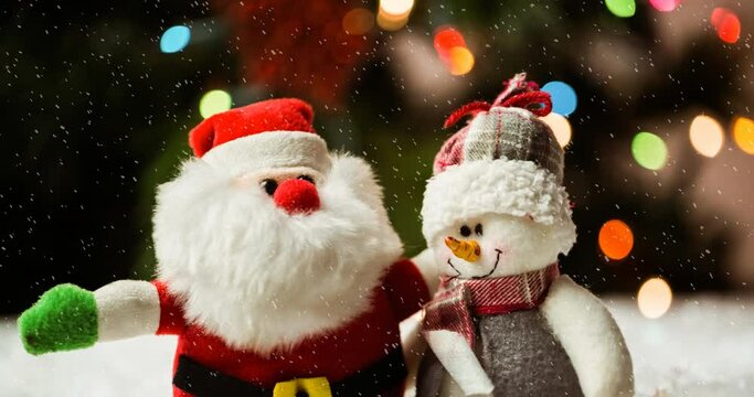 Animation of christmas santa claus and snowman with snow falling