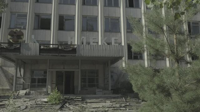 Tilt down derelict office block in Pripyat 