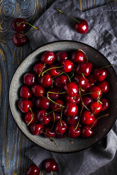 Sweet cherry in a bowl on a wooden table