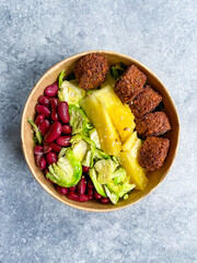 Healthy Food Bowl with Falafel, Pineapple, Mexican Red Kidney Beans and Brussel Sprouts in Plastic Bowl / Box or Container Package.