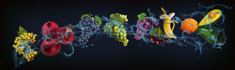 Panorama with fruits in water - juicy grapes, pomegranate, banana, orange, avocado are full of vitamins and minerals