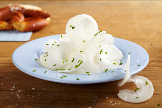 Salted radish spirals on a plate with pretzels as a bavarian snack