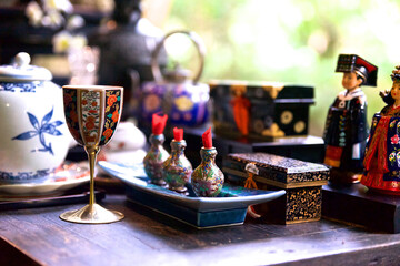 decorative wine glass in focus on the foregroundtea ceremony in the east, clay teapot and green tea cup, Chinese tradition of tea drinking