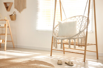 Fototapeta na wymiar Comfortable hammock chair in stylish room. Home interior