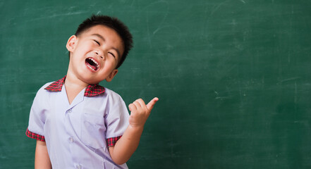 Back to School. Happy Asian funny cute little child boy from kindergarten in student uniform...