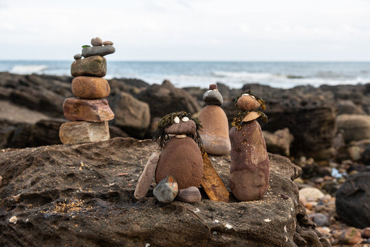 Rock people at the beach, built by children. A landscape image of a bunch of rock people created by my children when we spent a day at the beach at Crail, Fife, Scotland.