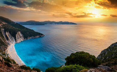 The famous Myrtos beach on the Greek island of Kefalonia, Ionian Sea, during a summer sunset with fluorescent, blue sea