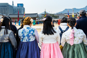 Tourist watching the warriors of the Royal guard in historical costumes in daily Ceremony of Gate Guard Change near the Gwanghwamun