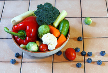 composition of a set of healthy food products: paprika, celery, cauliflower, broccoli, carrot, cucumber, blueberries, tomato