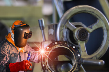 Obraz na płótnie Canvas Industrial Worker at the factory welding closeup
