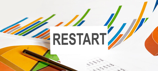 RESTART text on paper on chart background with pen