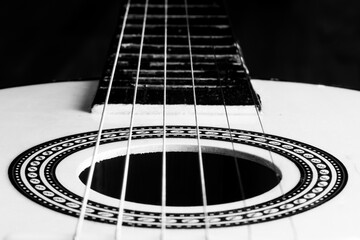 Isolated toy guitar closeup. Acoustic guitar. Black and white selected focus photography.