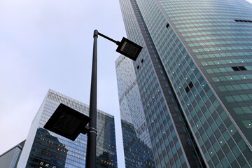 LED street lamp post on skyscrapers background. Modern led lights in city, corporate business