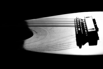 Isolated toy guitar closeup. Acoustic guitar. Black and white selected focus photography.